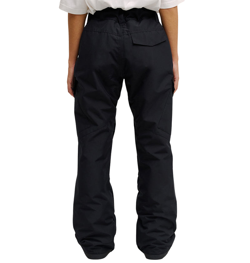 A person is standing with their back to the camera, wearing DC Shoes’ Nonchalant Pant—a pair of black, loose-fitting insulated pants featuring a flap pocket on the right side and engineered for optimal snow performance—paired with a white shirt.