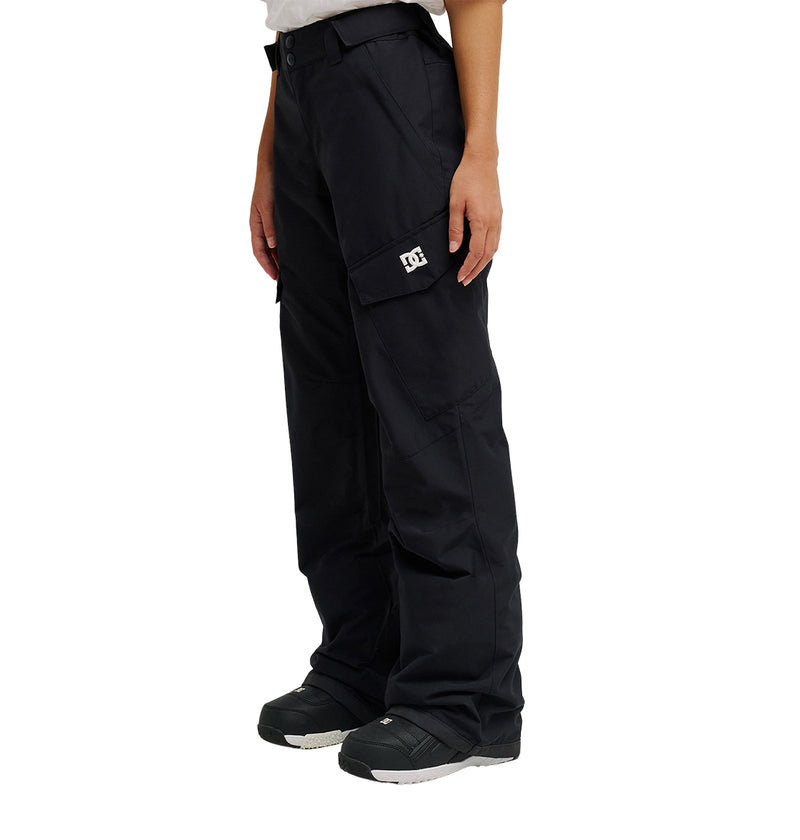 A person is wearing the DC Shoes Nonchalant Pant in black, paired with black shoes and standing against a plain white background. Only the lower half of the body is shown, highlighting the Nonchalant Pant’s practical style inspired by durable snow pants.