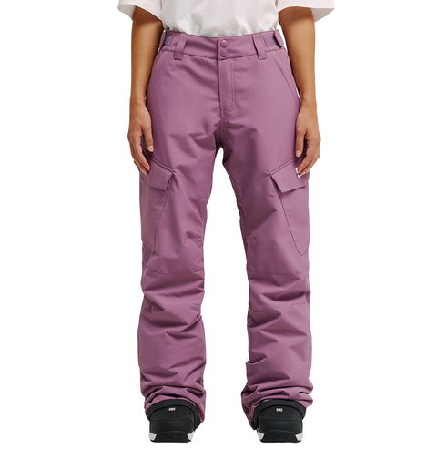 A person wearing a white shirt and the DC Shoes Nonchalant Pants in mauve, paired with black snow boots, stands against a white background. With their hands at their sides, they’re prepared for optimum snow performance and protection thanks to advanced waterproofing.