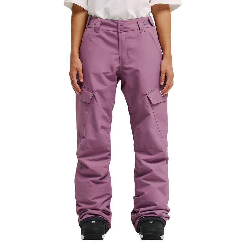 A person wearing a white shirt and the DC Shoes Nonchalant Pants in mauve, paired with black snow boots, stands against a white background. With their hands at their sides, they’re prepared for optimum snow performance and protection thanks to advanced waterproofing.