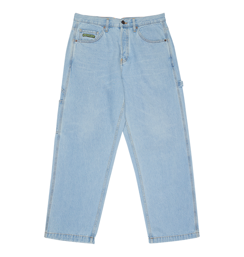 The DC Shoes Men's Baggy Denim Carpenter Pant in light blue features a relaxed, straight wide-leg fit with side pockets, belt loops, heavyweight denim, and a small green patch on the front right pocket.