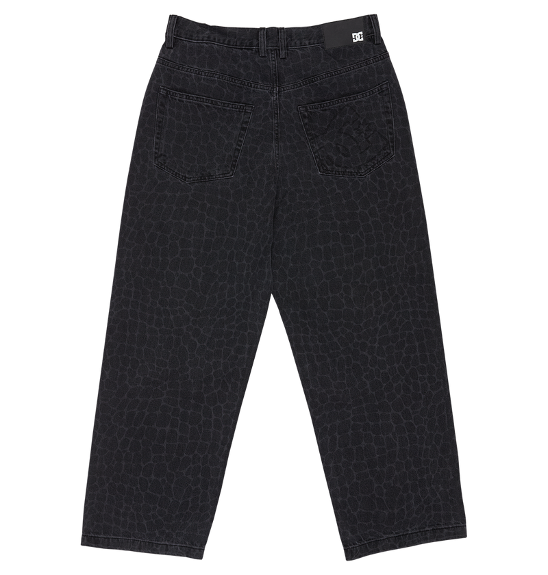 The DC Shoes Men's Baggy Denim Snake Print Pant features black denim with a subtle snake print, two back pockets, belt loop waistband, a logo tag on the right back waist, and a baggy straight fit. Displayed flat on a white background.