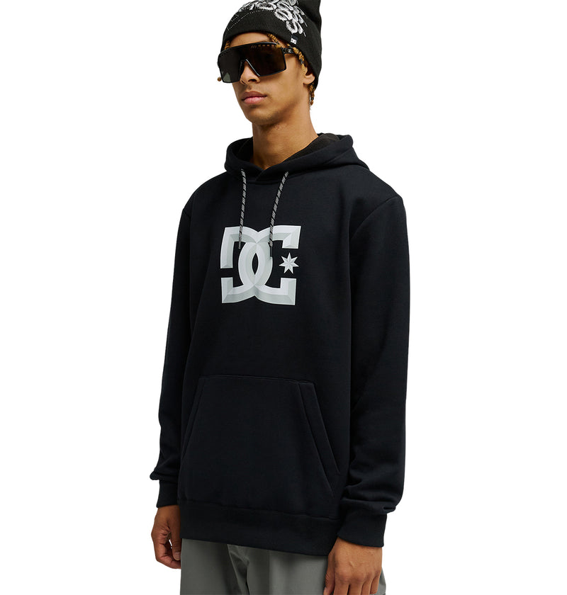 A person stands against a white background, wearing the DC Shoes Snowstar hoodie—renowned for its weather protection and comfortable fit—paired with sunglasses and a black beanie featuring white patterns.