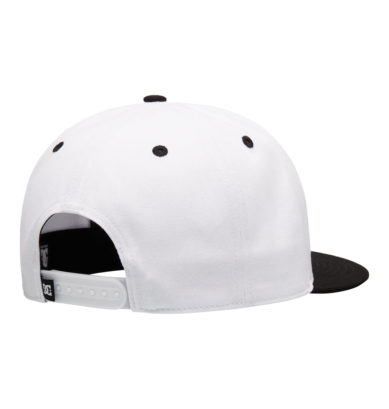 The Reebok DC Double That Cap is a white snapback with a black brim, black ventilation eyelets, and an adjustable white plastic strap, shown from the back.