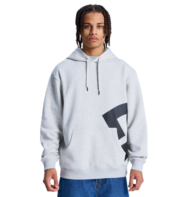 A person with braided hair wears the Reebok Lanai Ph light gray hoodie with a large black graphic on one side and blue jeans, standing against a plain white background.