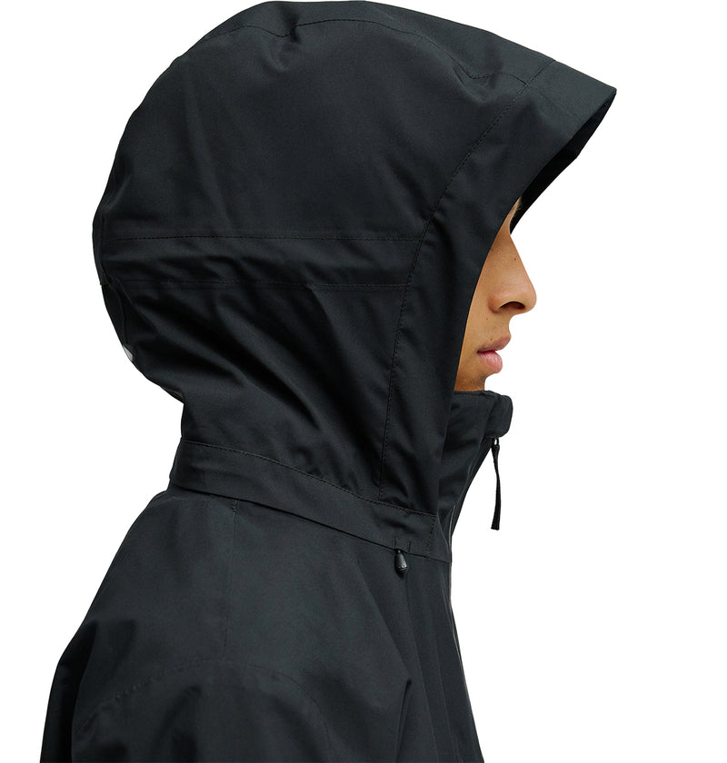A person in profile view wears the DC Shoes Edge Jacket 20K in black, with the hood up covering most of their head, set against a plain white background.