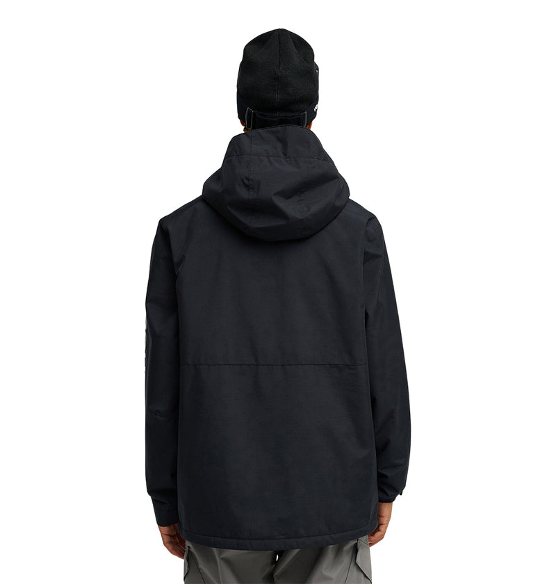 A person is shown from the back, wearing the DC Shoes Basis Jacket 10K in black with a hood and a black beanie, standing against a plain white background.