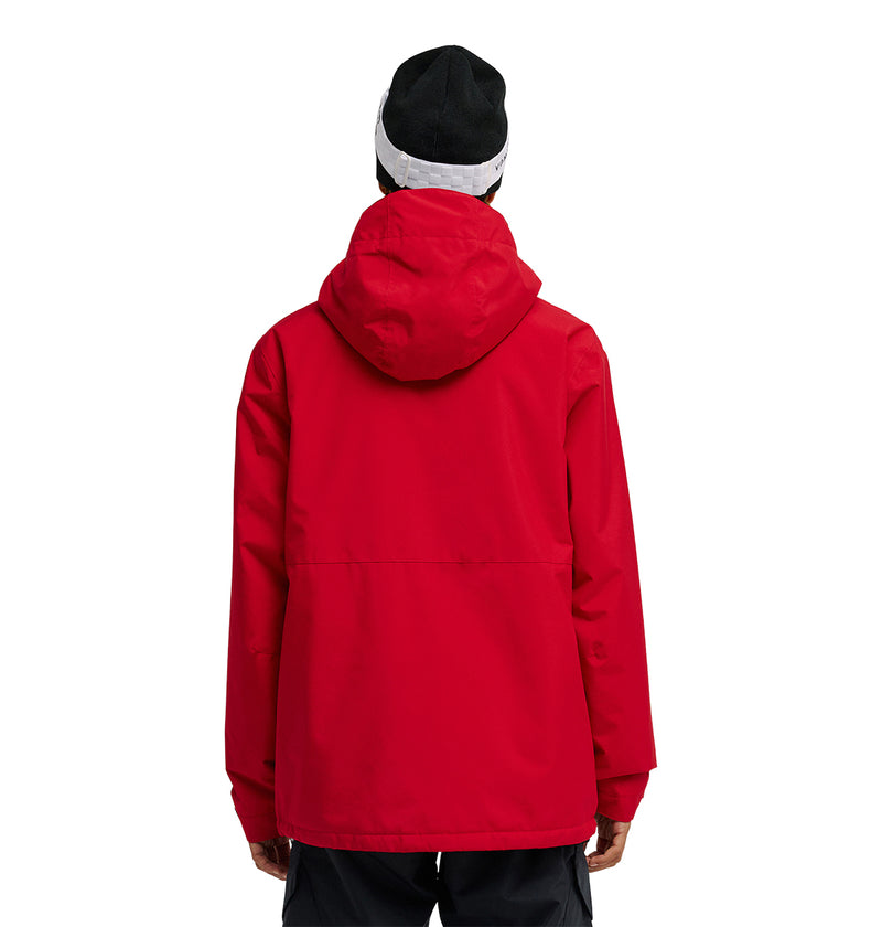 A person is shown from the back against a plain white background, wearing the DC Shoes Basis Jacket 10K in red with a hood, paired with black pants and a black and white beanie.