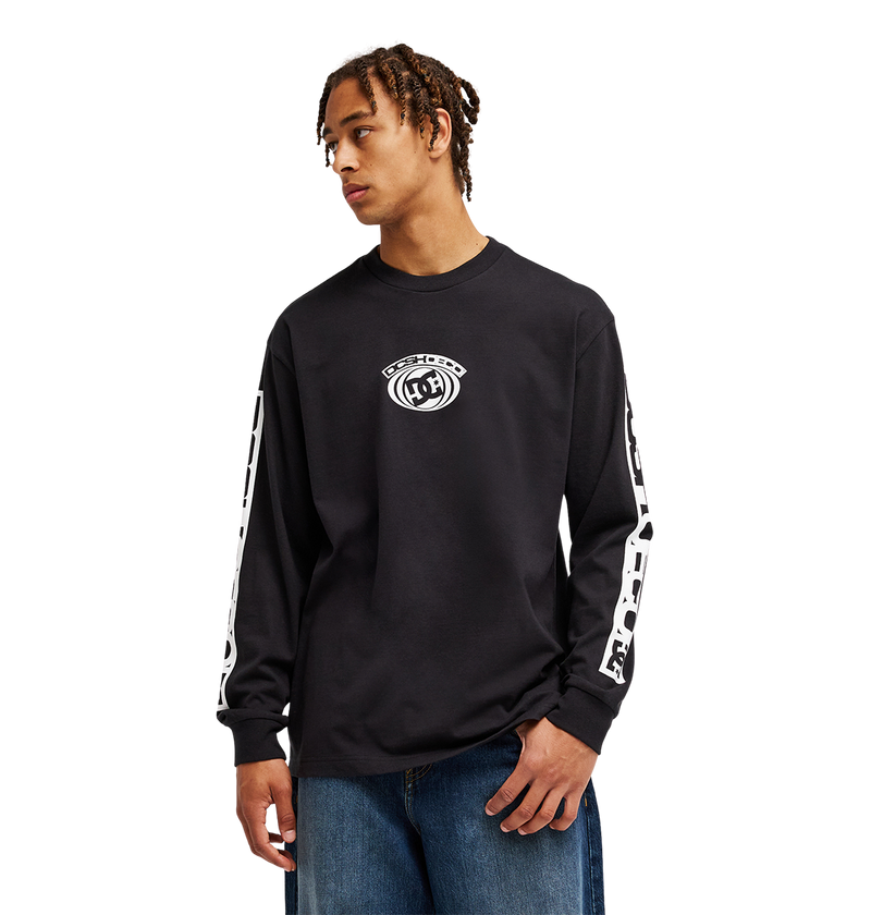 A person wearing the Men's DC Echo Tee by DC Shoes, a black long-sleeve graphic shirt featuring white graphics on the sleeves and chest, stands against a plain white background, looking to the side.