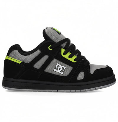 Black sneaker with green accents on a white background