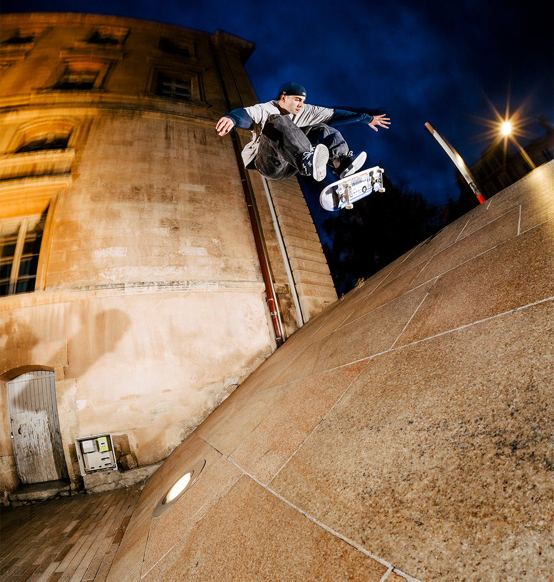 A man who doing a skateboarding trick wearing the Lynx shoes in Navy/Red