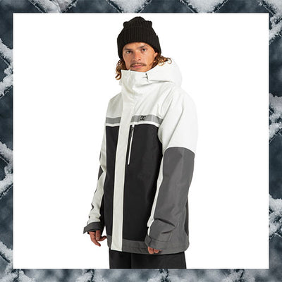 Person wearing a white and black jacket with a textured gray and white background