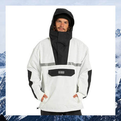 Person wearing a white and black jacket with a hood, standing against a snowy mountain background.