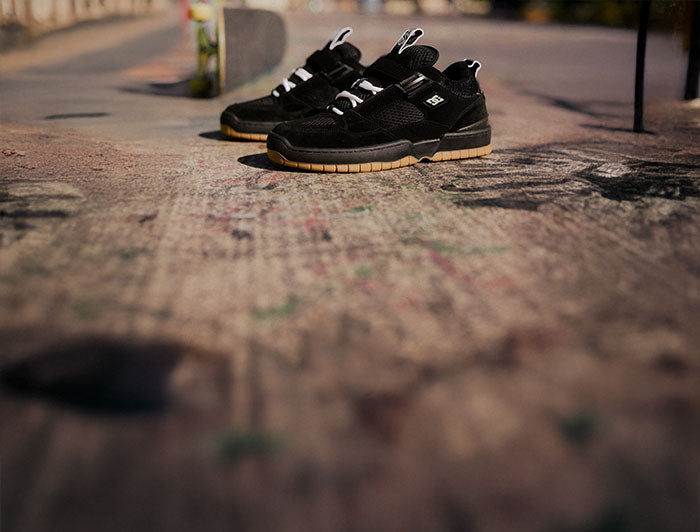 Black sandals on a textured pavement surface