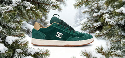 Green sneaker with a white logo on a snowy background