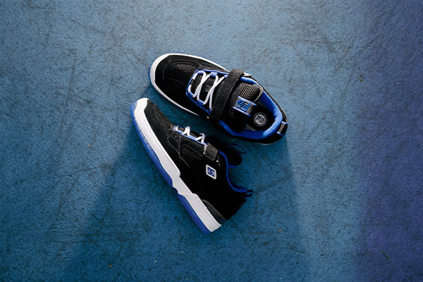Black and blue sneakers on a textured blue surface