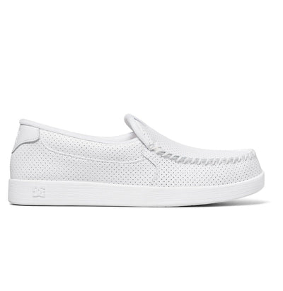 White slip-on shoe with a perforated leather upper, visible stitching around the toe, and a flat rubber sole. The design is minimalist and casual, suitable for everyday wear.