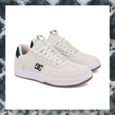 White sneakers with a brand logo on a marble background