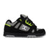 Black sneaker with green accents and a visible brand logo on a white background