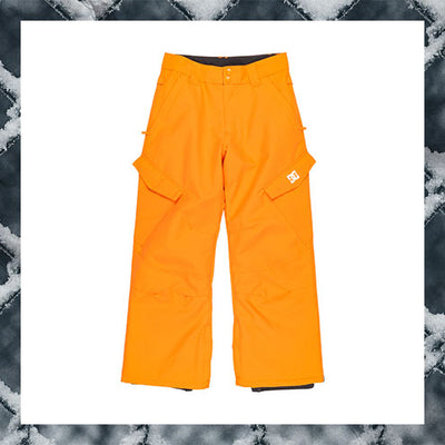 Orange snow pants with a brand logo on a snowy background