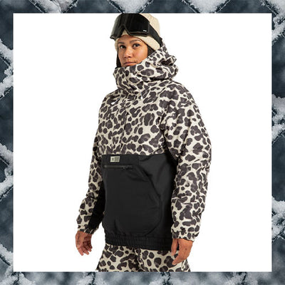 Person wearing a leopard print jacket and black pants with a white background