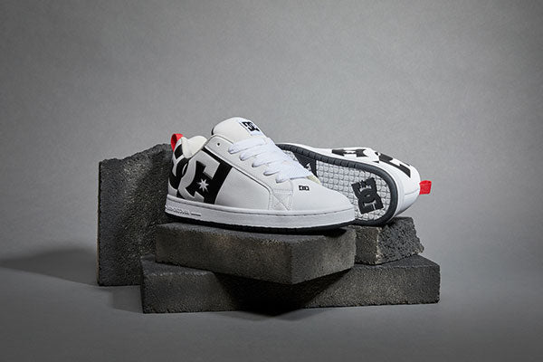 White Court Graffik sneakers on stone bricks in a studio