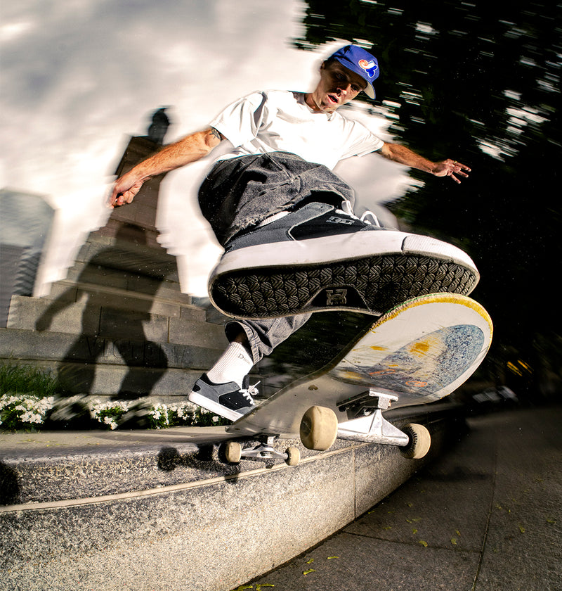 Skateboarder performing a trick on a skateboard with a blurred background